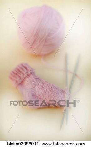 Semi-finished knitted pink baby sock with a ball of wool and knitting needles View Large Photo Image Stock Image - Semi-finished knitted pink baby sock with a ball of wool and knitting needles. Fotosearch