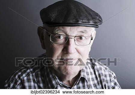Picture - "Senior citizen, elderly man, with a cap and glasses, portrait". Fotosearch