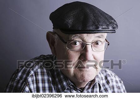 Stock Photograph - "Senior citizen, elderly man, with a cap and glasses, portrait". Fotosearch