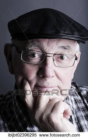 Stock Photography - "Senior citizen, elderly man, with a cap and glasses, portrait". Fotosearch