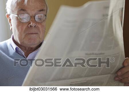 Stock Photograph - Senior citizen reading a newspaper. Fotosearch