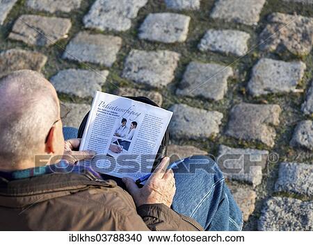 "Senior citizen sitting on a bench studying a brochure for making a """"Patientenverfugung"""", German for """"living will"""", Berlin, Germany, Europe" View Large Photo Image Stock Image - "Senior citizen sitting on a bench studying a brochure for making a """"Patientenverfugung"""", German for """"living will"""", Berlin, Germany, Europe". Fotosearch