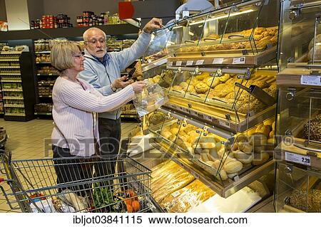 "Senior couple shopping at a self-service bakery shop in the supermarket, Germany, Europe" View Large Photo Image Stock Photography - "Senior couple shopping at a self-service bakery shop in the supermarket, Germany, Europe". Fotosearch