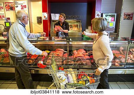 "Senior couple shopping at the meat counter in the supermarket, Germany, Europe" View Large Photo Image Stock Photo - "Senior couple shopping at the meat counter in the supermarket, Germany, Europe". Fotosearch