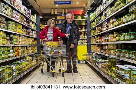 "Senior couple shopping in a supermarket, Germany, Europe" View Large Photo Image Stock Image - "Senior couple shopping in a supermarket, Germany, Europe". Fotosearch