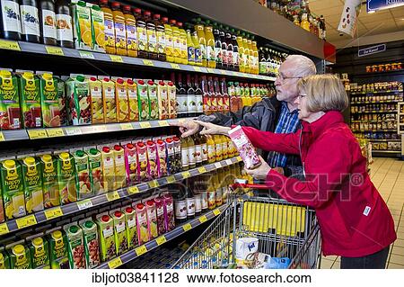 Stock Photo - "Senior couple shopping in a supermarket, Germany, Europe". Fotosearch