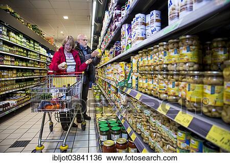 Stock Photograph - "Senior couple shopping in a supermarket, Germany, Europe". Fotosearch