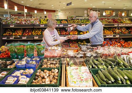 "Senior couple shopping in the fruit and vegetables department of a supermarket, Germany, Europe" View Large Photo Image Stock Photo - "Senior couple shopping in the fruit and vegetables department of a supermarket, Germany, Europe". Fotosearch