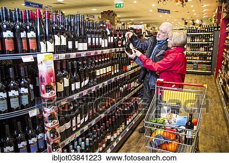 "Senior couple shopping in the wine department in a supermarket, Germany, Europe" View Large Photo Image Stock Image - "Senior couple shopping in the wine department in a supermarket, Germany, Europe". Fotosearch