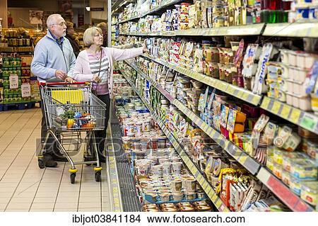 "Senior couple shopping with a shopping trolley in the refrigerated dairy section in a supermarket, Germany, Europe" View Large Photo Image Picture - "Senior couple shopping with a shopping trolley in the refrigerated dairy section in a supermarket, Germany, Europe". Fotosearch