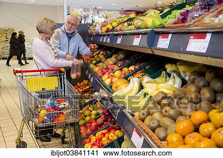 "Senior couple shopping with a shopping trolley in the fruit and vegetables department of a supermarket, Germany, Europe" View Large Photo Image Stock Image - "Senior couple shopping with a shopping trolley in the fruit and vegetables department of a supermarket, Germany, Europe". Fotosearch