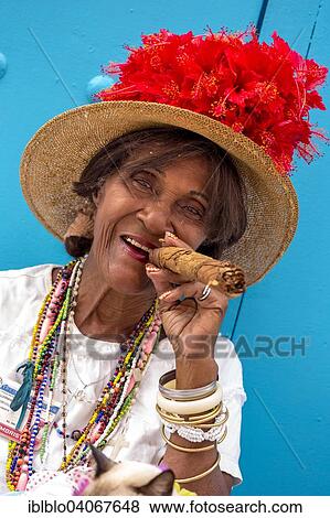 "Senior Cuban woman smoking a Cuban cigar, Havana, Cuba, North America" View Large Photo Image Stock Photo - "Senior Cuban woman smoking a Cuban cigar, Havana, Cuba, North America". Fotosearch