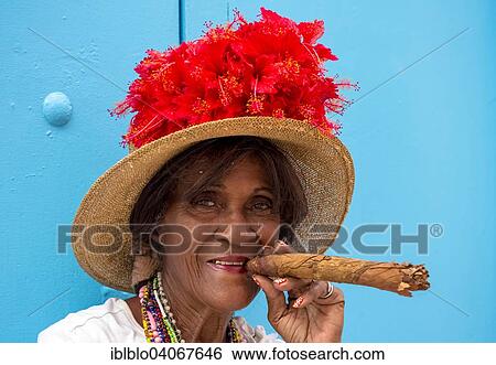 "Senior Cuban woman smoking a Cuban cigar, Havana, Cuba, North America" View Large Photo Image Stock Photograph - "Senior Cuban woman smoking a Cuban cigar, Havana, Cuba, North America". Fotosearch