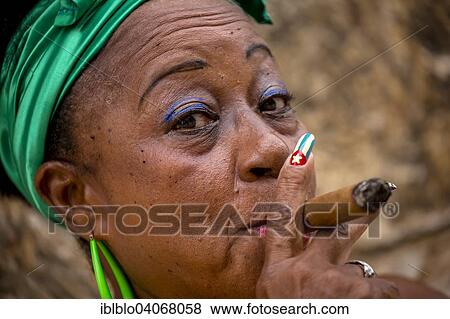 "Senior Cuban woman with the Cuban flag painted on her fingernail smoking a Cuban cigar, Havana, Cuba, North America" View Large Photo Image Stock Photo - "Senior Cuban woman with the Cuban flag painted on her fingernail smoking a Cuban cigar, Havana, Cuba, North America". Fotosearch