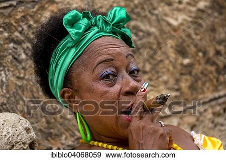 "Senior Cuban woman with the Cuban flag painted on her fingernail smoking a Cuban cigar, Havana, Cuba, North America" View Large Photo Image Stock Photo - "Senior Cuban woman with the Cuban flag painted on her fingernail smoking a Cuban cigar, Havana, Cuba, North America". Fotosearch