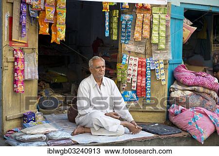 "Senior Indian man sitting on a blanket in front of his stall, Jodhpur, Rajasthan, India, Asia" View Large Photo Image Stock Image - "Senior Indian man sitting on a blanket in front of his stall, Jodhpur, Rajasthan, India, Asia". Fotosearch