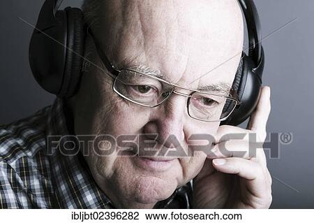 Senior wearing headphones View Large Photo Image Stock Image - Senior wearing headphones. Fotosearch