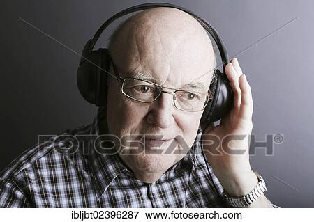 Stock Photo - Senior wearing headphones. Fotosearch
