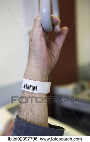 "Senior with a barcode wristband in a hospital, detail of a hand holding a hand grip on a bed" View Large Photo Image Stock Photograph - "Senior with a barcode wristband in a hospital, detail of a hand holding a hand grip on a bed". Fotosearch