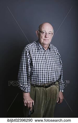 Stock Image - Senior with a walking stick. Fotosearch