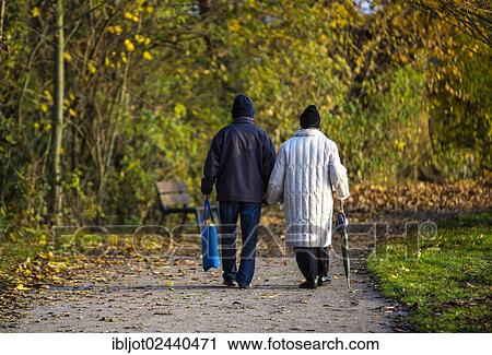 "Seniors, pensioners, couple taking an autumn stroll, holding hands" View Large Photo Image Stock Image - "Seniors, pensioners, couple taking an autumn stroll, holding hands". Fotosearch