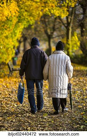 "Seniors, pensioners, couple taking an autumn stroll, holding hands" View Large Photo Image Stock Image - "Seniors, pensioners, couple taking an autumn stroll, holding hands". Fotosearch
