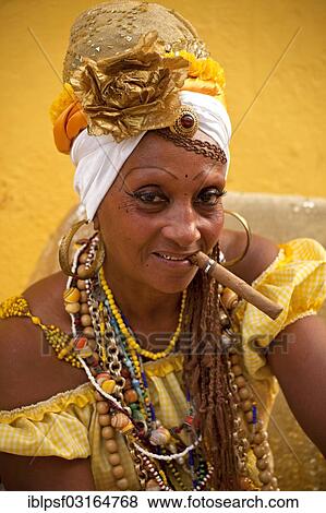 "Senora Habana, a priestess of the Afro-Cuban Santeria or Santera, with a cigar, Havana, Cuba, North America" View Large Photo Image Stock Photo - "Senora Habana, a priestess of the Afro-Cuban Santeria or Santera, with a cigar, Havana, Cuba, North America". Fotosearch