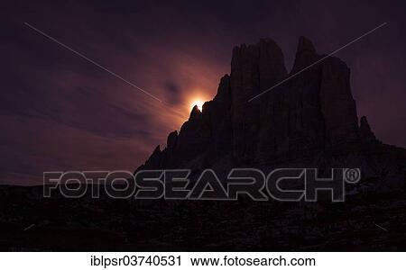 Stock Image - "Setting full moon on the edge of the smaller Three Peaks, Hochpustertal valley, Sexten, South Tyrol province, Trentino-Alto Adige, Italy, Europe". Fotosearch