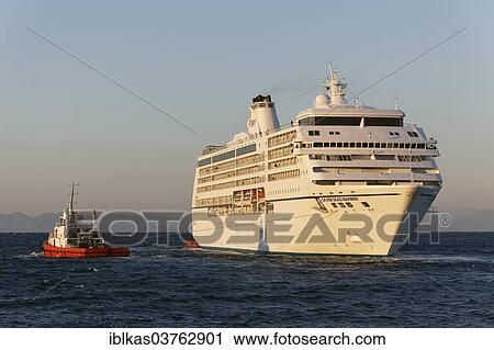 "Seven Seas Mariner"""" cruise ship of Regent Seven Seas Cruises is towed out to sea, Rhodes, Rhodes island, Dodecanese, Greece, Europe" View Large Photo Image Stock Image - "Seven Seas Mariner"""" cruise ship of Regent Seven Seas Cruises is towed out to sea, Rhodes, Rhodes island, Dodecanese, Greece, Europe". Fotosearch