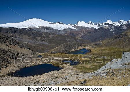 Stock Image - "Several mountain lakes in a high valley, at the back the snow capped mountains of the Cordillera Raura range, North Peru, Peru, South America". Fotosearch