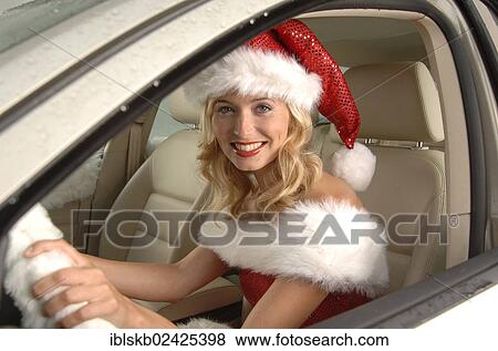 Stock Photo - Sexy female Santa sitting in a car. Fotosearch