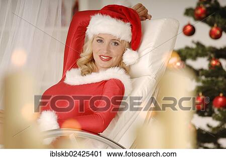 Sexy female Santa sitting on a sofa View Large Photo Image Stock Image - Sexy female Santa sitting on a sofa. Fotosearch