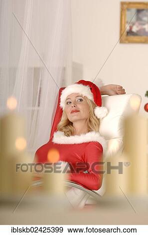 Sexy female Santa sitting on a sofa View Large Photo Image Stock Photo - Sexy female Santa sitting on a sofa. Fotosearch