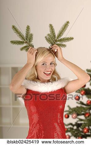 Sexy Miss Santa with pine branches as horns View Large Photo Image Stock Photo - Sexy Miss Santa with pine branches as horns. Fotosearch