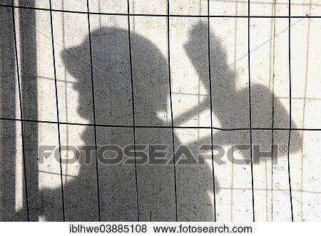 "Shadow of a construction worker on a concrete wall, symbolic image for black labour, illegal employment, Germany, Europe" View Large Photo Image Stock Photo - "Shadow of a construction worker on a concrete wall, symbolic image for black labour, illegal employment, Germany, Europe". Fotosearch