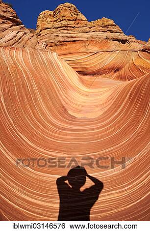 "Shadow of a photographer at """"The Wave"""", wave of banded eroded Navajo sandstone rocks with Liesegang bands, Coyote Buttes North, CBN, Pahreah or Paria Canyon, Vermilion Cliffs National Monument, Arizona, United States, North America" View Large Photo Image Stock Photograph - "Shadow of a photographer at """"The Wave"""", wave of banded eroded Navajo sandstone rocks with Liesegang bands, Coyote Buttes North, CBN, Pahreah or Paria Canyon, Vermilion Cliffs National Monument, Arizona, United States, North America". Fotosearch