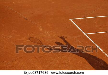 Stock Photograph - "Shadow of a tennis player serving the ball, French Open 2013, ITF Grand Slam Tennis Tournament, Roland Garros, Roland Garros Stadion, Paris, Ile-de-France, France, Europe". Fotosearch