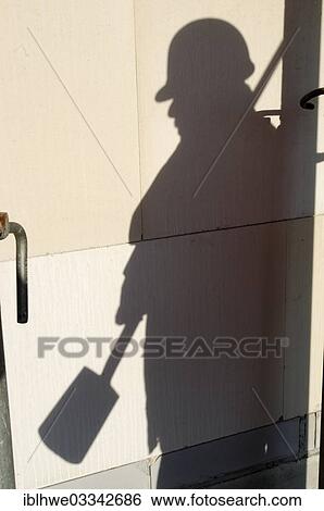 "Shadow of a worker with hard hat and spade, symbolic image for black labour, black economy, Hamburg, Hamburg, Germany, Europe" View Large Photo Image Stock Photograph - "Shadow of a worker with hard hat and spade, symbolic image for black labour, black economy, Hamburg, Hamburg, Germany, Europe". Fotosearch