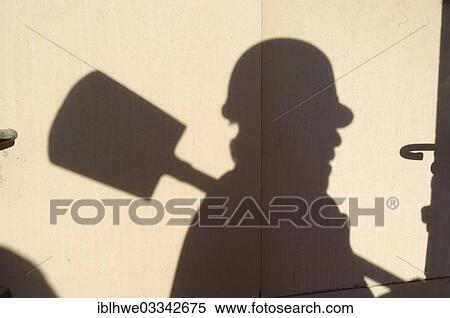 "Shadow of a worker with hard hat and spade, symbolic image for black labour, black economy, Hamburg, Hamburg, Germany, Europe" View Large Photo Image Stock Photography - "Shadow of a worker with hard hat and spade, symbolic image for black labour, black economy, Hamburg, Hamburg, Germany, Europe". Fotosearch
