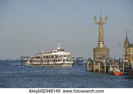"Ship entering the Lake Constance harbour entrance with the Imperia statue by sculptor Peter Lenk, Konstanz, Baden-Wuerttemberg, Germany, Europe" View Large Photo Image Stock Photo - "Ship entering the Lake Constance harbour entrance with the Imperia statue by sculptor Peter Lenk, Konstanz, Baden-Wuerttemberg, Germany, Europe". Fotosearch