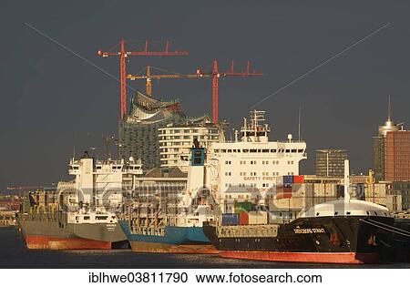 Stock Image - "Ships in the Port of Hamburg at anchor in the North Elbe, Elbe Philharmonic Hall and the Marco Polo Tower in the back, Hamburg, Germany, Europe". Fotosearch