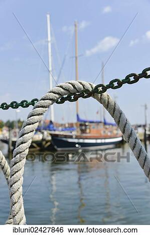 "Ship's rope hanging over a chain, Schlei, Schleswig-Holstein, Germany, Europe" View Large Photo Image Stock Photograph - "Ship's rope hanging over a chain, Schlei, Schleswig-Holstein, Germany, Europe". Fotosearch