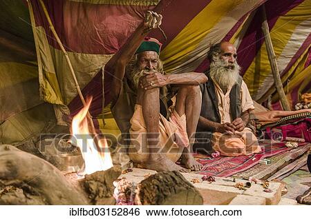Stock Photograph - "Shiva sadhu, holy man, Juna Akhara, practising Urdha tapa, lifting an arm for many years for spiritual reasons, in his tent, during Kumbha Mela, Allahabad, Uttar Pradesh, India, Asia". Fotosearch