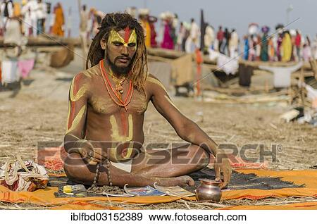 Stock Photo - "Shiva sadhu, holy man, meditating at the Sangam, the confluence of the rivers Ganges, Yamuna and Saraswati, during Kumbha Mela festival, Allahabad, Uttar Pradesh, India, Asia". Fotosearch