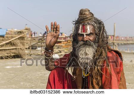 Stock Photograph - "Shiva sadhu, holy man, sitting at the Sangam, the confluence of the rivers Ganges, Yamuna and Saraswati, during Kumbha Mela festival, Allahabad, Uttar Pradesh, India, Asia". Fotosearch