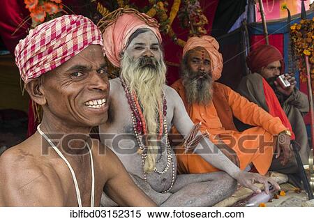 Stock Photography - "Shiva sadhus, holy men, sitting in a tent at the Sangam, the confluence of the rivers Ganges, Yamuna and Saraswati, during Kumbha Mela festival, Allahabad, Uttar Pradesh, India, Asia". Fotosearch