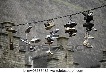 "Shoes hanging on a rope between taverns, symbol for bilks, Ghent, Flemish Region, Belgium, Europe" View Large Photo Image Stock Image - "Shoes hanging on a rope between taverns, symbol for bilks, Ghent, Flemish Region, Belgium, Europe". Fotosearch