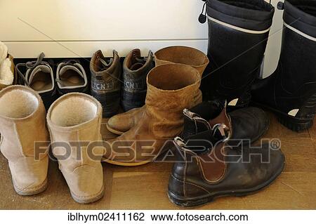 Shoes standing on a wooden floor in a hallway View Large Photo Image Stock Image - Shoes standing on a wooden floor in a hallway. Fotosearch