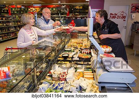 "Shop assistant serving a senior couple at the cheese counter, shopping in a supermarket, Germany, Europe" View Large Photo Image Picture - "Shop assistant serving a senior couple at the cheese counter, shopping in a supermarket, Germany, Europe". Fotosearch