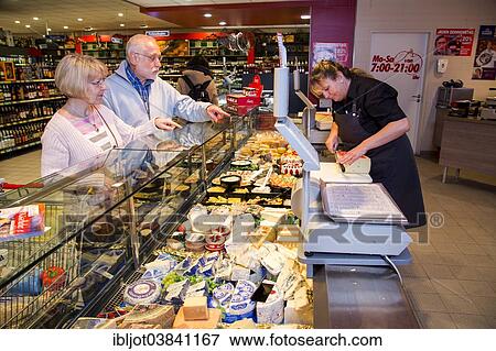 "Shop assistant serving a senior couple at the cheese counter, shopping in a supermarket, Germany, Europe" View Large Photo Image Stock Photo - "Shop assistant serving a senior couple at the cheese counter, shopping in a supermarket, Germany, Europe". Fotosearch